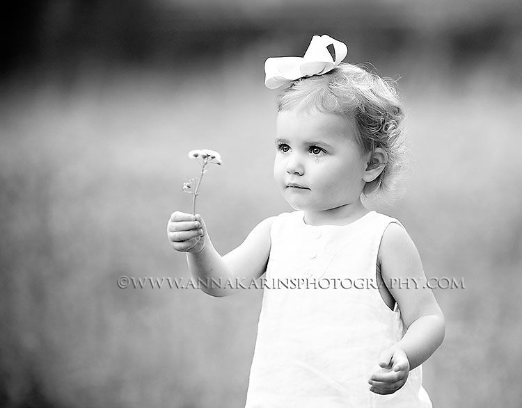 Teardrop-on-cheek, little sad girl with tears, beautiful outdoor portrait of litle girl picking flowers