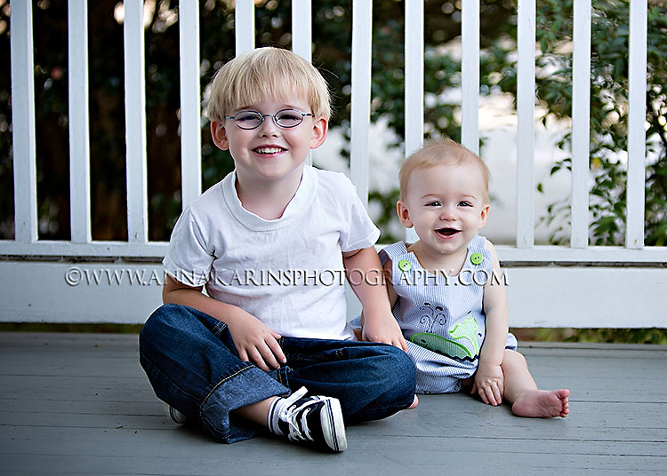 Brothers, siblings on porch with white fence, Family and child photographer Baton Rouge