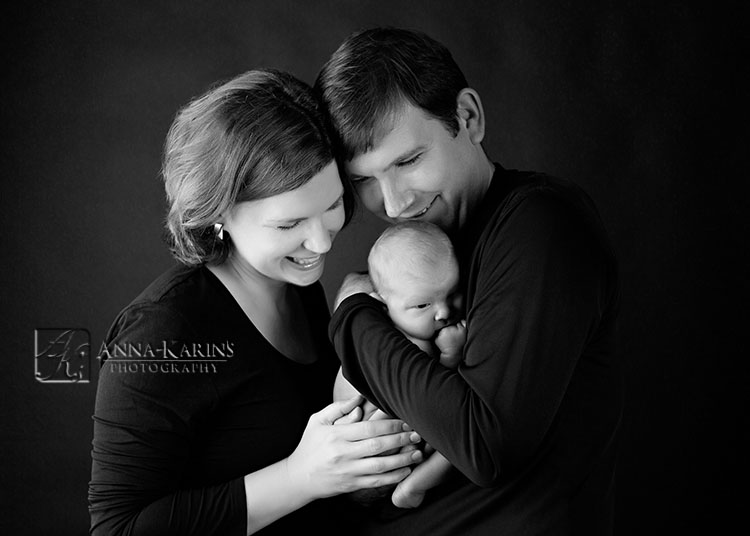 Beautiful portrait of parents with their newborn baby boy. timeless contemporary portrait of a newborn baby