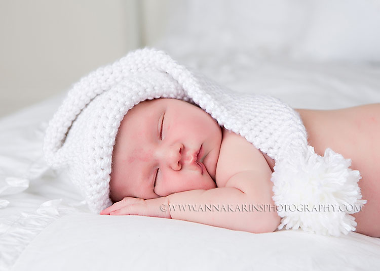 sleepy newborn baby boy on white, sleeping baby with knitted white hat