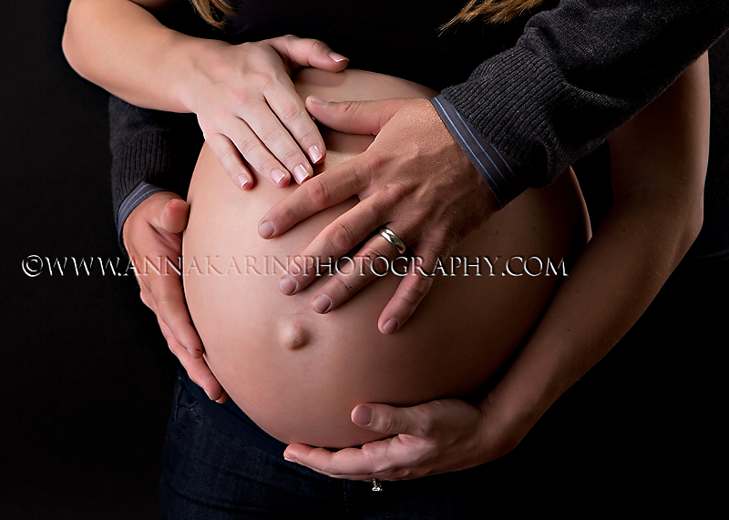 Pregnancy photographs, hands on pregnant belly, a couple expecting their first baby