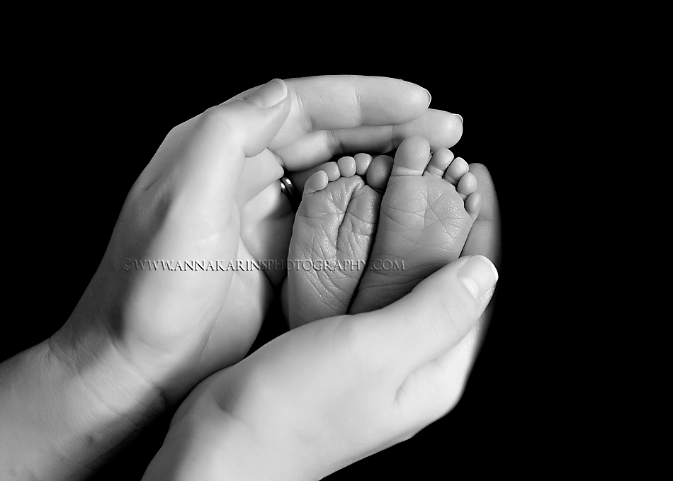 Sweet little baby toes in mamas hands